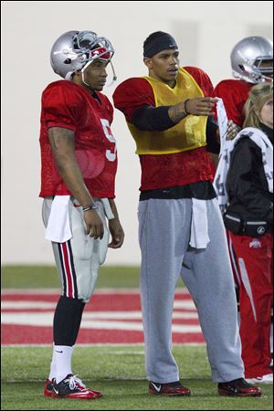 Terrelle Pryor, right, is recovering from foot surgery and is suspended for the first five games, so he has spent a lot of time this spring mentoring Braxton Miller.