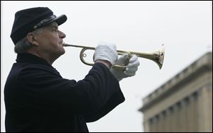 Jim Cherven of Battery H, 1st Ohio Light Artillery, plays Taps as the ceremony ends. The tune was arranged by Union Gen. Daniel Butterfield and was used by both Union and Confederate forces.