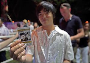 A Vietnamese student shows his checked ticket before entering the one-night-only show at RMIT University in Ho Chi Minh City.