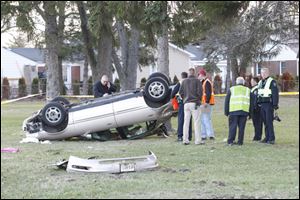 Emergency responders investigate a crash off the eastbound Anthony Wayne Trail in Maumee in which a man was killed Tuesday morning.