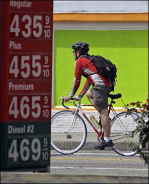 A bicyclist passes a gas station in Los Angeles as fuel costs rise above the $4 mark. With the price of gas above $3.50 a gallon in all but one state, there are signs that Americans are cutting back on driving, reversing a steady increase in demand for fuel as the economy improves. Other modes of mass transportation, such as bus transit, have been an option, while buying and driving more fuel-efficient vehicles also have become more popular.