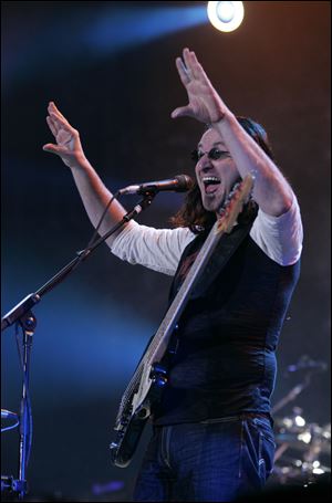 Rush bassist/vocalist Geddy Lee performs one of the band's biggest hits, 'The Spirit of Radio', which opened the concert Wednesday night at the Huntington Center.