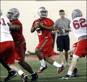 Ohio State quarterback Braxton Miller (5) drops back to pass during a practice earlier this spring in Columbus.