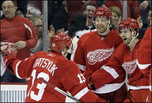 Detroit Red Wings Pavel Datsyuk (13), Brad Stuart, center, and Justin Abdelkader celebrate a goal by teammate Darren Helm.