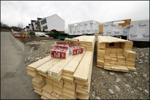 Housing materials await construction at a development in Canonsburg, Pa. As housing prices fall, more buyers are turning to resale. New-home sales have fallen to the lowest they've been since 1963.