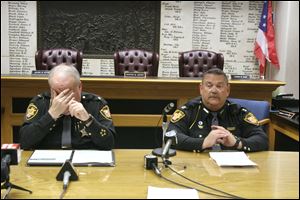 Ottawa County Sheriff Bob Bratton, left, and Olen Martin tell of the scene at 964 Leutz Rd. 