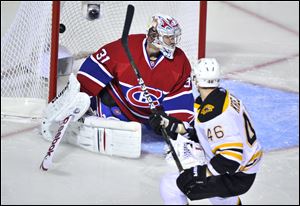 Boston’s David Krejci scores past Montreal goaltender Carey Price Monday night. The Bruins lead 2-1 in the series.