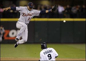 Seattle Mariners' Chone Figgins (9) slides safely into second base on a stolen base as Detroit Tigers shortstop Jhonny Peralta leaps for, and misses, an errant throw in the fourth inning.