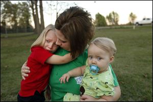Courtney Kemp, widow of Roy Wyatt Kemp, 27, who died in the Deepwater Horizon oil rig explosion, holds her daughers Kaylee Kemp, 3, and Madisson Kemp, 9 months, in Jonesville, La., in this Nov. 11, 2010 file photo.