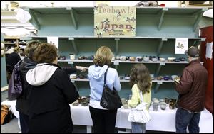 Ceramic tea bowls, made in the style of Japanese tea bowls, are offered for sale by Bowling Green State University ceramics students. Proceeds will be sent to the Mashiko Potters Fund in northern Japan.