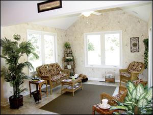 This charming sunroom is the perfect spot to relax
with a cup of coffee in the morning.