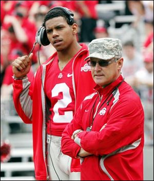 Quarterback Terrelle Pryor and coach Jim Tressel keep a close eye on the game. Pryor didn’t play as he continues to recover from an ankle injury.