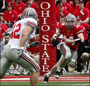 Joe Bauserman looks to get off a pass as Andrew Sweat closes in. Bauserman completed four of his 11 passes.
