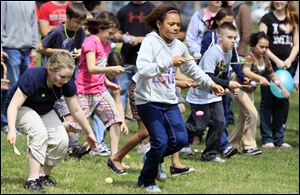 Kar’Lee Edwards, 9, of Sandusky focuses on keeping her egg on the spoon at the Rutherford B. Hayes Presidential Center. About 300 youngsters ages 3-10 took part in the annual egg roll on Saturday.
