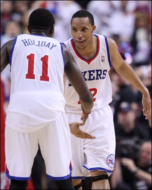 Philadelphia's Evan Turner, right, celebrates with Jrue Holiday late in Game 4 against Miami.