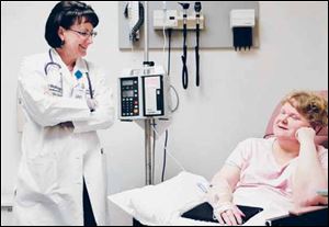 Elizabeth Aton, right, undergoes a treatment for lupus administered by Teresa Arb, a nurse.