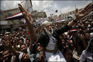 An anti-government protester is carried on others’ shoulders in a crowd in the capital demanding the immediate resignation of Yemen’s president, Ali Abdullah Saleh.