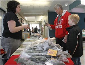From left, Amy Karlovec, Fred Gibson, and his grandson Brock Miesle, 6, of Perrysburg Township. 