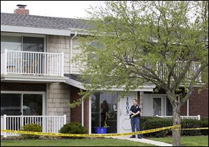 A Bowling Green police officer stands outside an apartment building at 1608 Clough Street in Bowling Green, where Blackwell was shot.