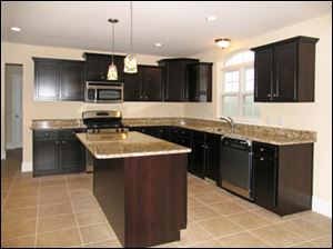 The kitchen includes a large island and stainless
appliances.