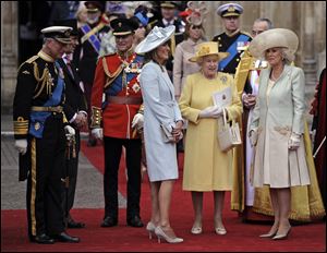 The royal couple's family, from left, Prince Charles, Prince Phillip, Carole Middleton, Queen Elizabeth II, and Camilla Duchess of Cornwall stand outside of Westminster Abbey after the ceremony.