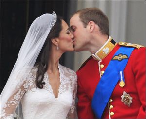 Britain's Prince William kisses his wife Catherine, Duchess of Cambridge, on the balcony of Buckingham Palace.