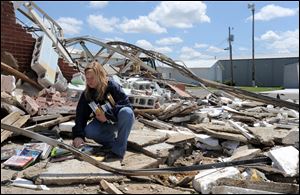Teacher Ginger Graham salvages books from a resource room at Plainview High School in Rainsville, Ala., after a tornado barreled through Dekalb County.