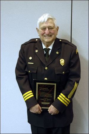Retired Fire Chief Chuck Hudson of Delta, Ohio, displays his Outstanding Service Award.