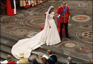 Prince William and Kate Middleton join hands during the wedding ceremony. Her dress, designed by Sarah Burton at Alexander McQueen, was the wedding’s best-kept secret.