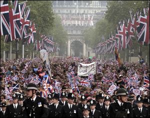 Spectators make their way down the Mall to Buckingham Palace after the Royal Wedding. Along the Mall, sidewalks were packed five or six people deep hoping to catch a glimpse of royal family members.
