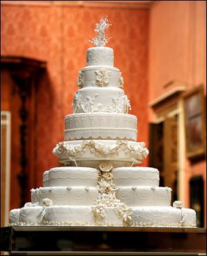 The eight-tiered wedding cake crafted by a team from Fiona Cairns Ltd. of Leicestershire is shown in the Picture Gallery of Buckingham Palace. The cake, comprised of 17 individual fruit cakes, features more than 900 individually iced flowers of 17 different designs. It was served alongside a chocolate biscuit cake.

