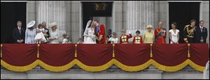 The Duke and Duchess of Cambridge share a kiss on the balcony of Buckingham Palace after the wedding. They are joined by members of the royal family and wedding party.