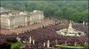 Thousands of well-wishers gather in London to witness the spectacle of the wedding. After barricades were removed, many rushed toward the gates of Buckingham Palace to catch a glimpse of the couple.