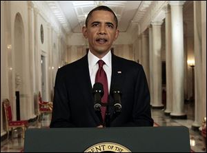 President Obama reads his statement to photographers after making a televised statement on the death of Osama bin Laden from the East Room of the White House Sunday.