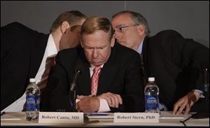 Dr. Robert Stern, right, and Chris Nowinski, left, confer before answering a reporter's question at the Boston University Center for the Study of Traumatic Encephalopathy news conference about the finding of Chronic Traumatic Encephalopathy in the brain of former NFL player Dave Duerson in Boston on Monday morning.