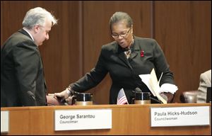 Councilman George Sarantou watches as Paula Hicks-Hudson take her seat on the Toledo City Council for the first time this past January.