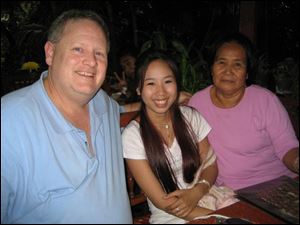 Carl Ralston, left, shown with Nhu Da Than and her grandmother, co-founded 'Remember Nhu,' a ministry that operates six homes in five Asian nations to house orphans at risk of human trafficking.