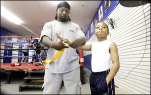 Wayne Lawrence, Sr., trains his son at Bang ‘Em or Hang ‘Em gym. He says he has no problem having a 9-year-old boxer, saying it’s Bam Bam’s job, although he admits getting nervous when he spars.