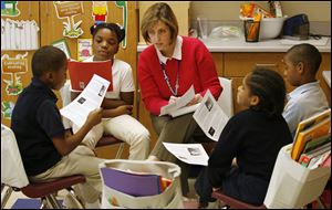Diane Pickering, an intervention assessment teacher, oversees a group of students at Spring Elementary School. Third grader Antonia Lopez, 10, next to Ms. Pickering, was ‘leading’ the group, which included Daniel Combs, 10, left, Russell Bland, 8, and Terrell Newble, 8. The lesson is part of the Reading Academy Intensive Support Education program that aims to boost reading scores.