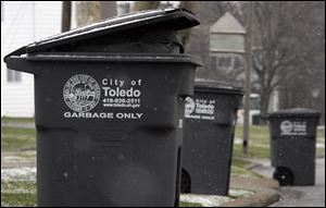 City of Toledo garbage bins ready for pick-up with the automated trash collection system on Celesta Dr. on the first day of the system on December 7, 2009.