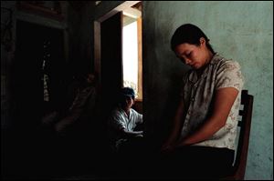 Kieu Thi Lan is often reminded of her grandfather, Kieu Cong, by other family members. She wonders why American soldiers shot and killed him.