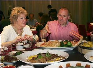 The Toledo Symphony's Kathy Carroll and real estate broker Scott Prephan dine with the delegation in Shenzhen. The group has sightseeing scheduled in between meetings during their nine-day trip.