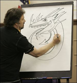 Artist Ralph Masiello demonstrates his work during Claire's Day at the Maumee Branch Library.