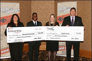 Veronica  Pinciotti, left, general manager of Buckeye CableSystem's local stations, presents a check to student of the year Keon Pearson, of St. Francis de Sales, and BCSN's  Tom Cole, far right, presents a check to teacher of the year Jackie Kane of St. Ursula Academy.