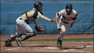 St. John’s junior catcher Corey Tipton tags out Whitmer’s Tyler LaFountain after a dropped-ball strikeout in the district final. Tipton has a .381 batting average.