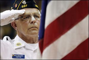 Don Zellner of Christ Dunberger American Legion Post 537 salutes during the 96th annual Memorial Day program at Waite High School. A $2,000 check was presented to Honor Flight of Northwest Ohio.