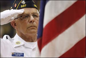 Don Zellner, a member of the Christ Dunberger American Legion Post 537, salutes the flag during a Memorial Day program Thursday at Waite High School.