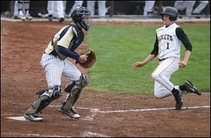 St. John's Jesuit High School catcher Corey Tipton waits for the throw as Perrysburg's Steve Slocum scores the winning run in the 12th inning of their Division I baseball regional semifinal at BGSU's Steller Field.