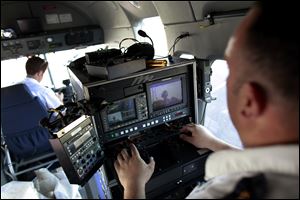 Lou Navarro, assistant chief electronics technician, tests an external camera mounted to the 