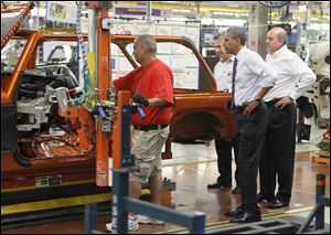 President Obama looks over a vehicle during a private tour of the Wrangler line. He said letting the auto industry fail would have meant closing plants like the one in Toledo.